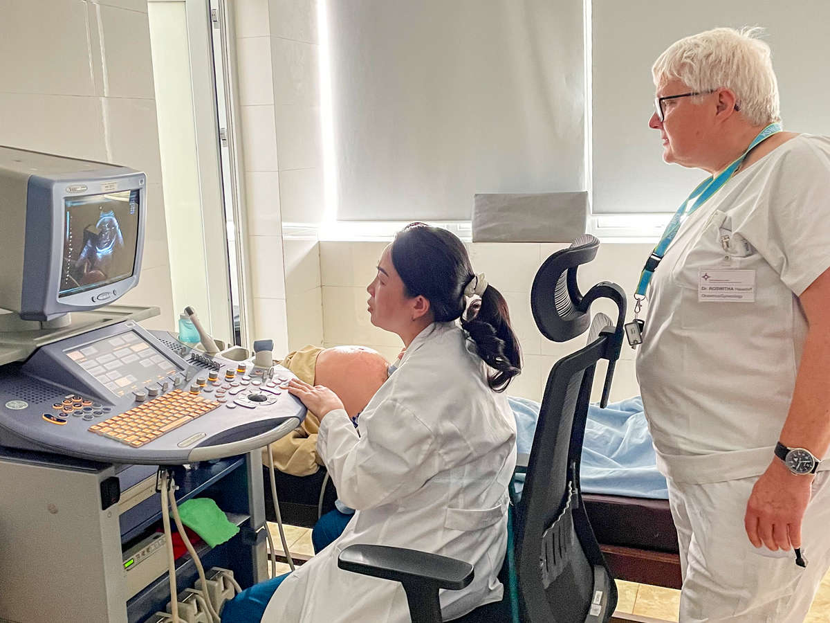 A medical specialist is performing an ultrasound examination.
